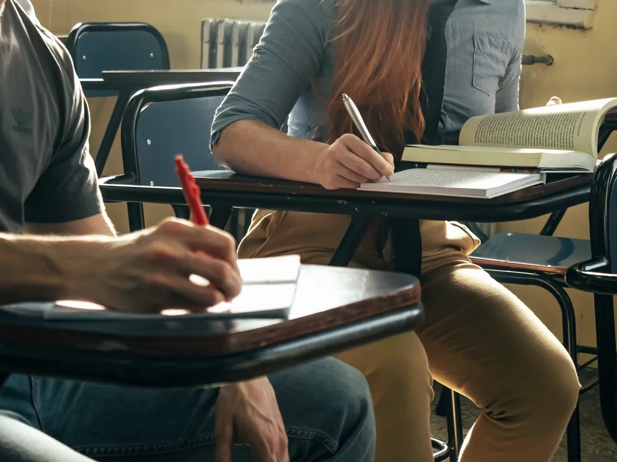 Students at desks in a classroom - the written preparation side of the training