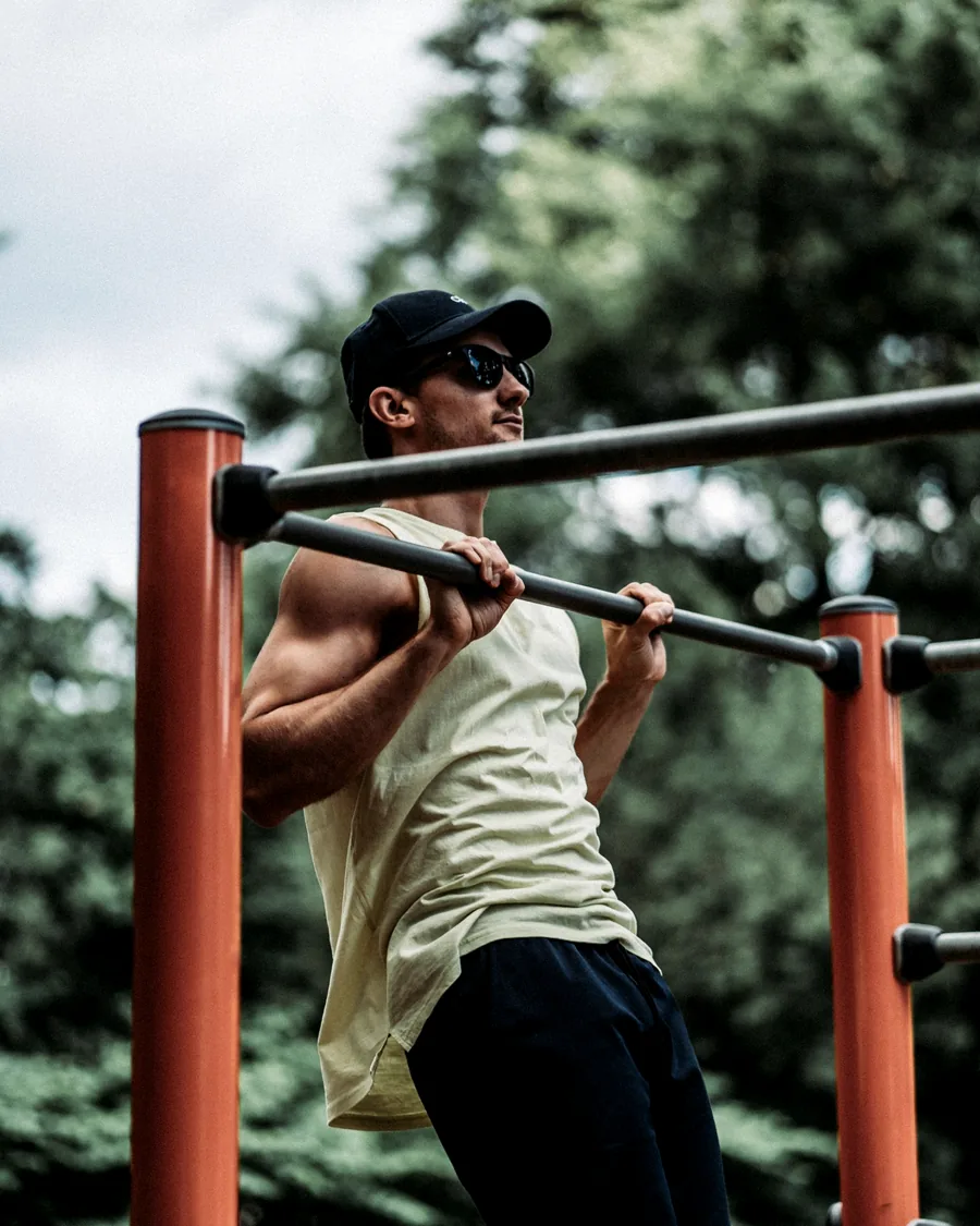 A candidate training on an outdoor pull-up bar